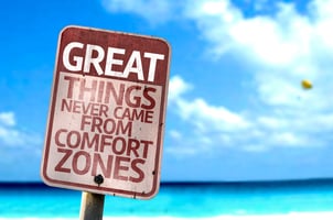 A motivational sign that reads "Great things never came from comfort zones," reinforcing the theme of the blog "Not Sure What’s Next? How to Use Time Between Jobs to Explore New Career Paths." The image symbolizes the importance of stepping outside of familiar routines to discover new opportunities.
